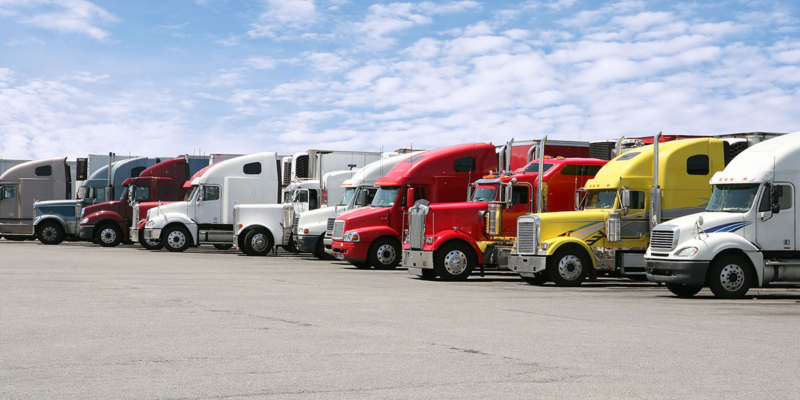 Line of semi trucks all parked side-by-side