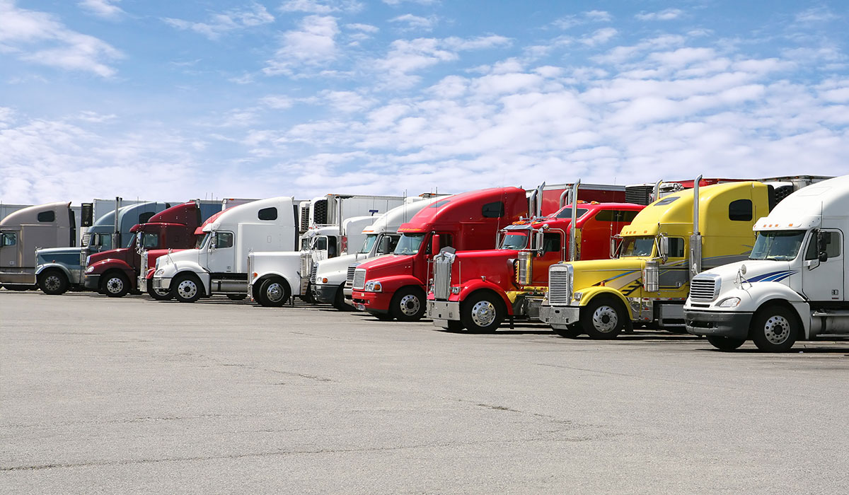 Line of semi trucks all parked side-by-side