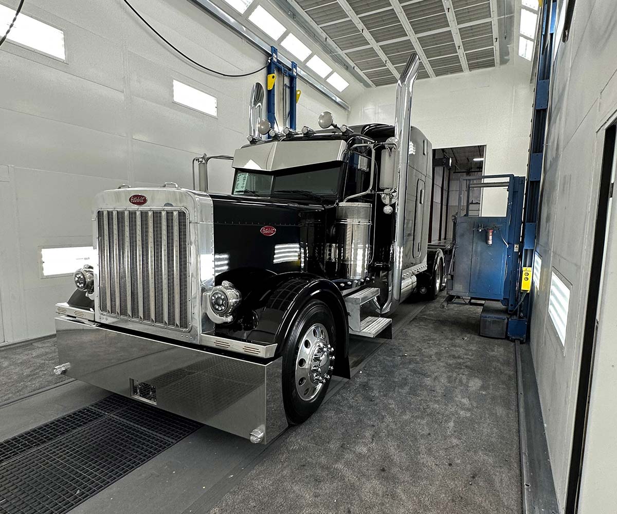 Peterbilt semi truck inside the paint booth