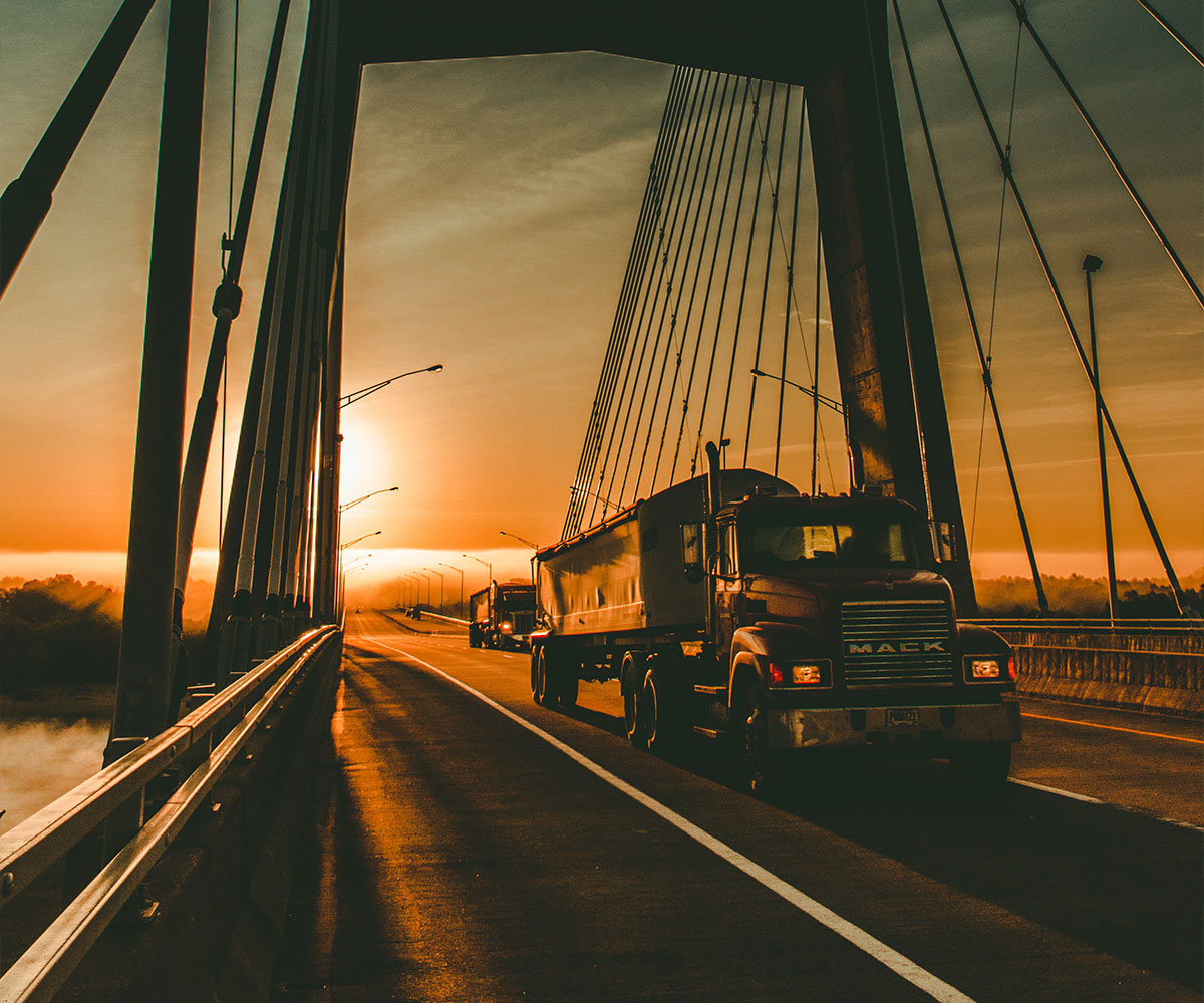 Mack semi truck crossing a cable bridge