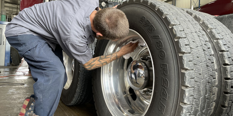 Maintenance being performed for a heavy duty truck.