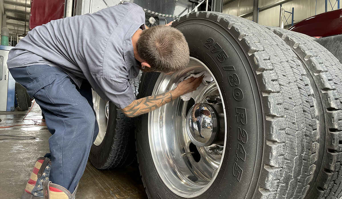 Maintenance being performed for a heavy duty truck.