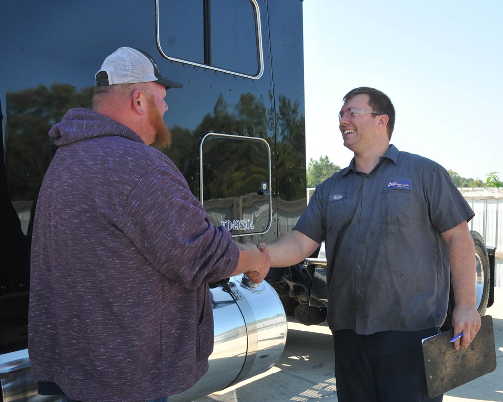 OTS employee shaking hands with customer