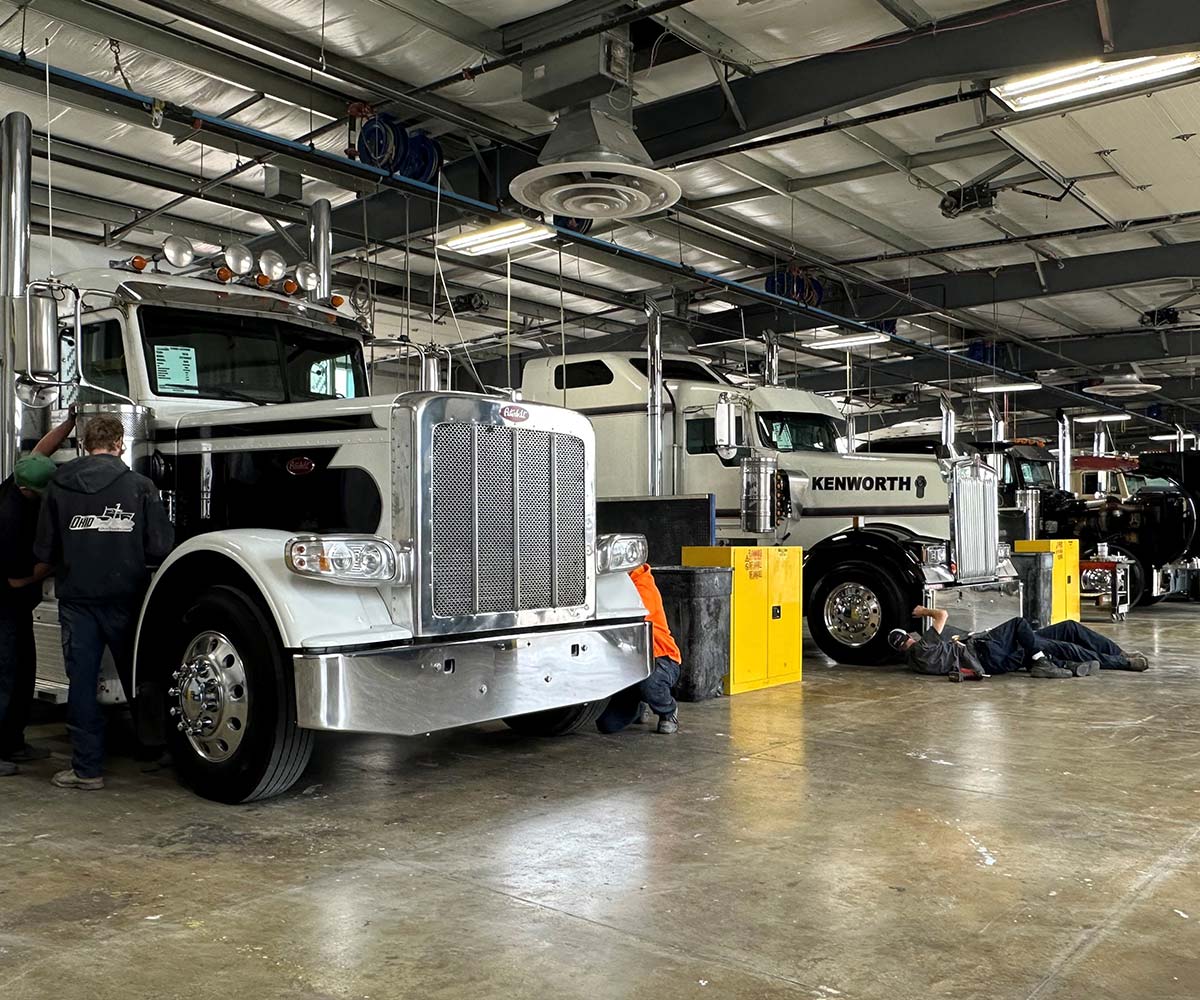 Mechanics working on Peterbilt and Kenworth semi trucks