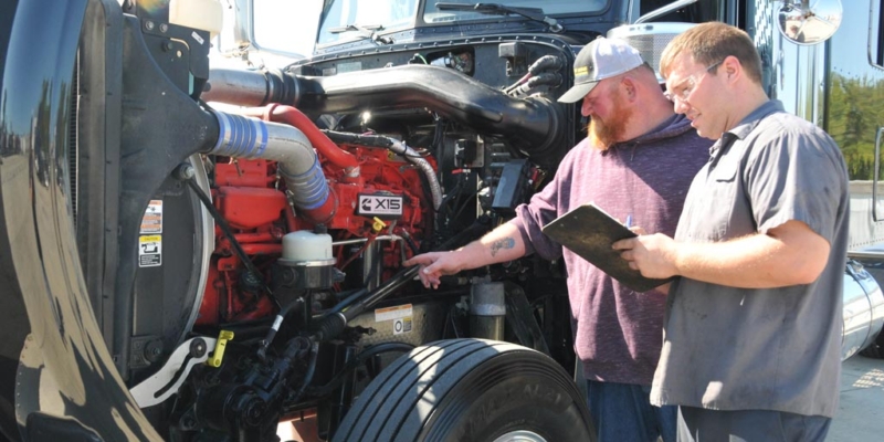 Certified appraiser inspecting used semi-truck